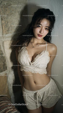 Young Woman in Elegant Lace Top Relaxing Indoors