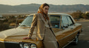 Stylish Woman in Beige Suit by Vintage Car and Desert