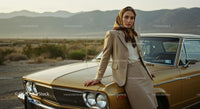 Elegant Woman Leaning on Vintage Car in Desert