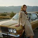 Elegant Woman in Vintage Fashion Leaning on Golden Car