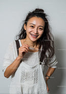 Smiling Woman with Dental Braces in White Sweater