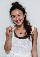 Smiling Woman Holding Clear Aligners for Dental Care