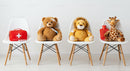 Stuffed Animals with First Aid Kit on White Chairs