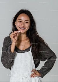 Smiling Woman with Dental Braces in Cozy Sweater