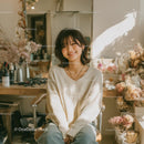 Smiling Woman Surrounded by Dried Flowers in Cozy Setting