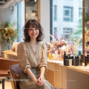 Smiling Woman in Elegant Blouse in Beauty Salon