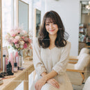 Smiling Woman in Elegant Hairstyle at Beauty Salon
