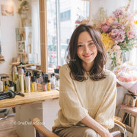 Smiling Woman in a Cozy Beauty Salon with Floral Decor