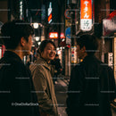 Friends Enjoying an Evening Stroll in Vibrant City Lights