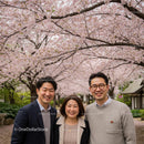 Smiling Group Under Cherry Blossom Trees in Spring