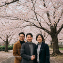 Smiling Group Under Cherry Blossom Trees in Spring