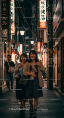 Young Women Strolling Through Vibrant Japanese Night Street