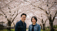 Smiling Couple Amidst Blooming Cherry Blossoms in Spring