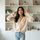 Smiling Woman in Cozy Beige Cardigan at Home