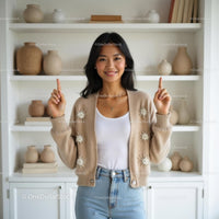 Smiling Woman in Beige Sweater Pointing Upward