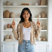 Smiling Woman in Cozy Beige Cardigan at Home