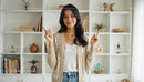 Smiling Woman in Cozy Sweater with Modern Bookshelf