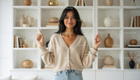 Smiling Woman in Cozy Sweater with Modern Bookshelf