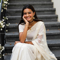 Elegant Woman in Pink Saree with Jewelry on Staircase