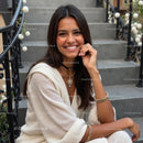 Smiling Woman in Elegant Outfit on Stone Steps