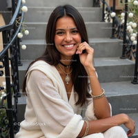 Smiling Woman in Elegant Outfit on Stone Steps