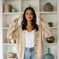 Smiling Woman in Cozy Beige Cardigan at Home