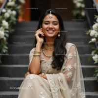 Elegant Woman in Pink Saree with Jewelry on Staircase