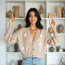 Smiling Woman in Cozy Beige Cardigan at Home