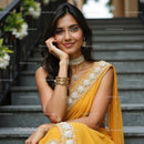 Elegant Woman in Pink Saree with Jewelry on Staircase