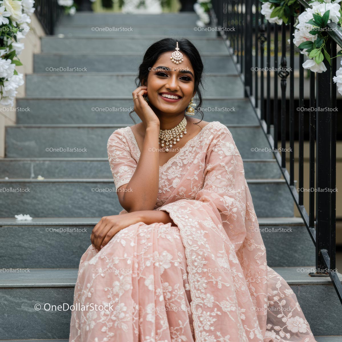 Woman in Pink Sari with Elegant Jewelry on Staircase