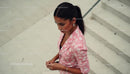Fashionable Woman in Pink Floral Blazer on Urban Steps