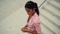 Fashionable Woman in Pink Floral Blazer on Urban Steps