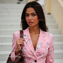 Stylish Woman in Pink Floral Blazer with Confident Expression