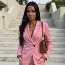 Confident Woman in Chic Pink Suit on Urban Steps