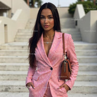 Confident Woman in Chic Pink Suit on Urban Steps