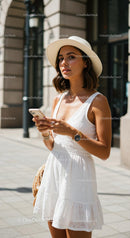 Stylish Woman in White Dress and Hat Using Smartphone