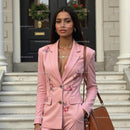 Elegant Woman in Floral Pink Suit Standing Outside