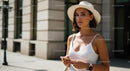 Fashionable Woman in White Dress Walking in Urban Setting