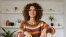 Smiling Woman in Cozy Sweater with Modern Bookshelf