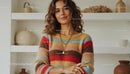 Smiling Woman in Cozy Sweater with Modern Bookshelf