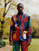 Man in Vibrant Multicolored Jacket Outdoors