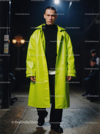 Young Man in Neon Green Coat Walking at Night