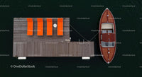 Aerial View of Dock with Wooden Boat and Orange Loungers