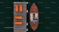 Luxury Yacht Docked Beside Orange Lounge Chairs on Wooden Pier