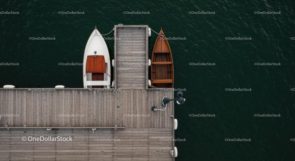 Aerial View of Wooden Dock with Boats in Calm Water