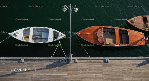 Classic Wooden and White Boats Moored at a Sunny Dock