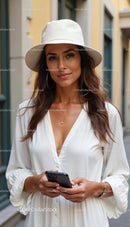 Elegant Woman in White Dress and Hat with Smartphone