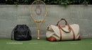 Tennis Racket with Stylish Travel Bags on Grass