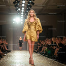 Fashion Model in Elegant Golden Dress on Runway