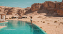 Woman Enjoying Infinity Pool by Desert Mountains